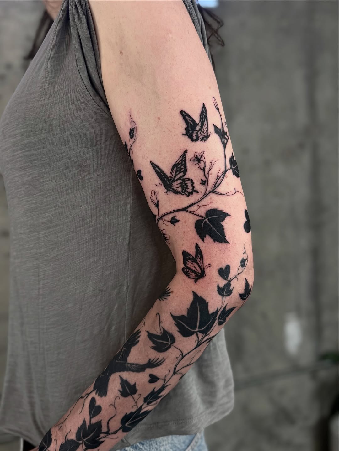 Elegant ivy and butterfly tattoo sleeve inspiration Tattoo Design