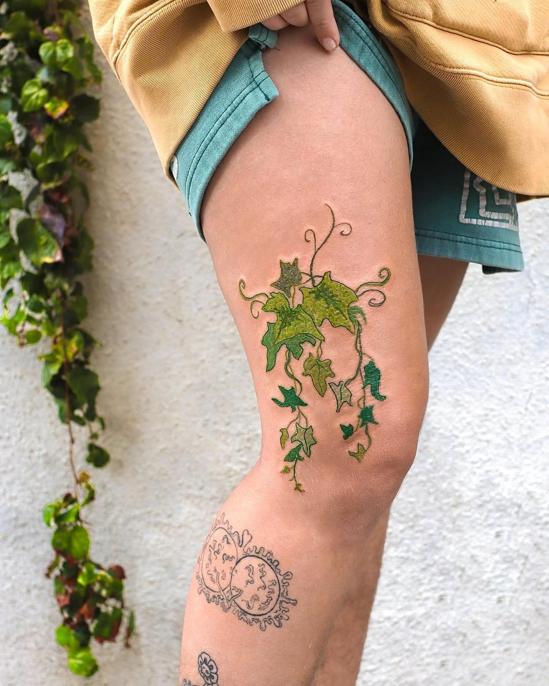 Elegant ivy tattoo cascading down the thigh Tattoo Design