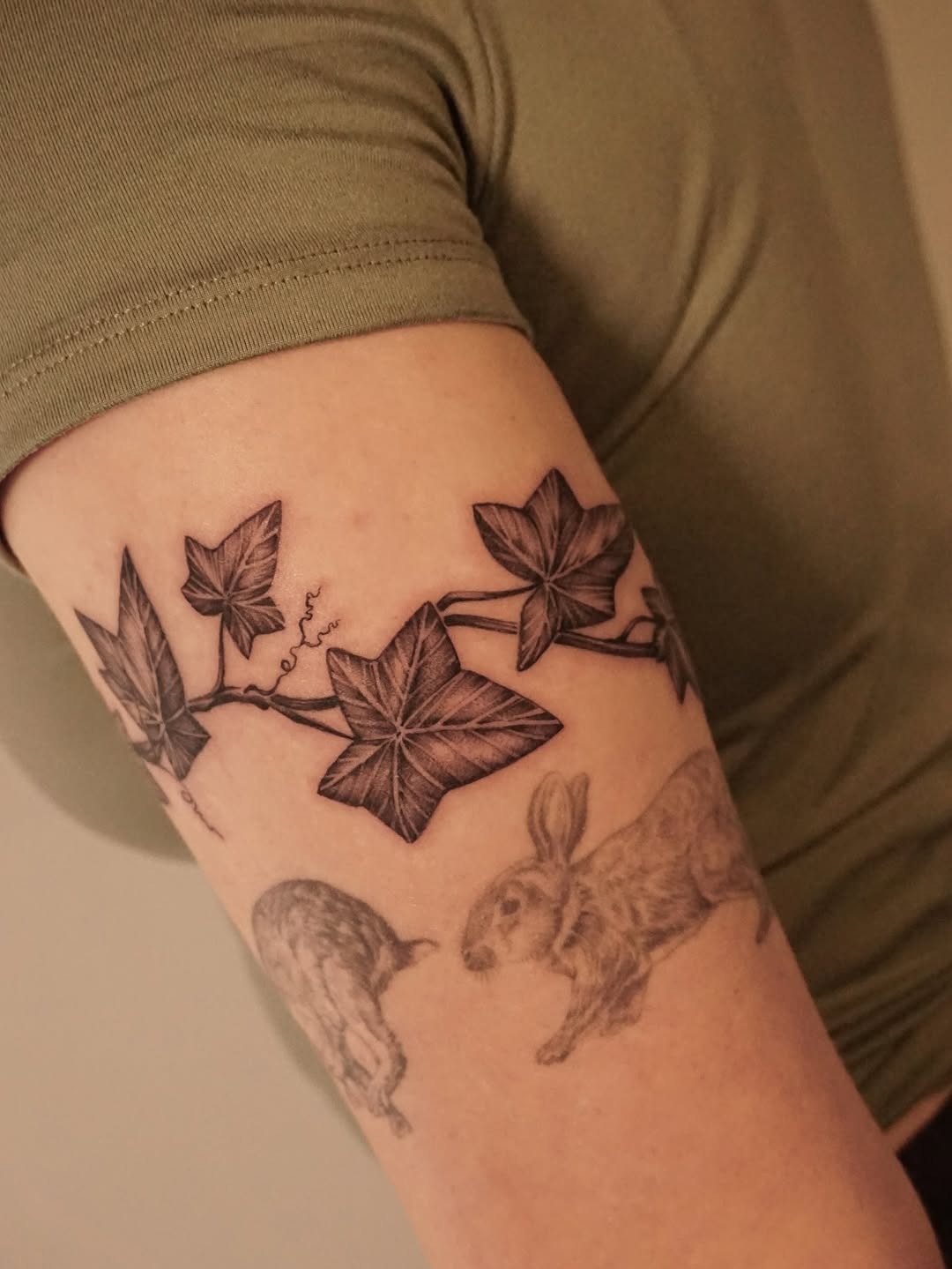 Elegant ivy tattoo intertwined with playful rabbits Tattoo Design