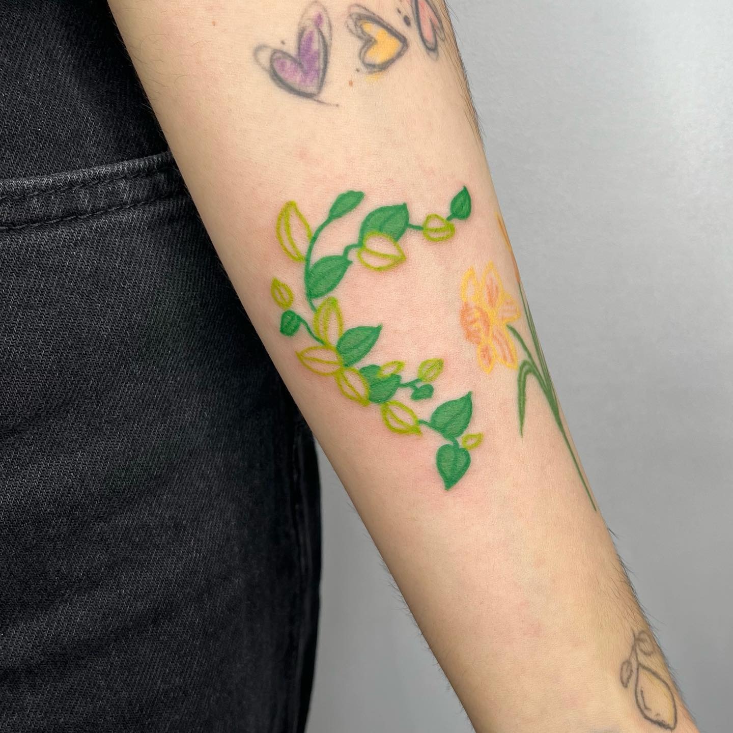 Elegant ivy tattoo with floral accents Tattoo Design