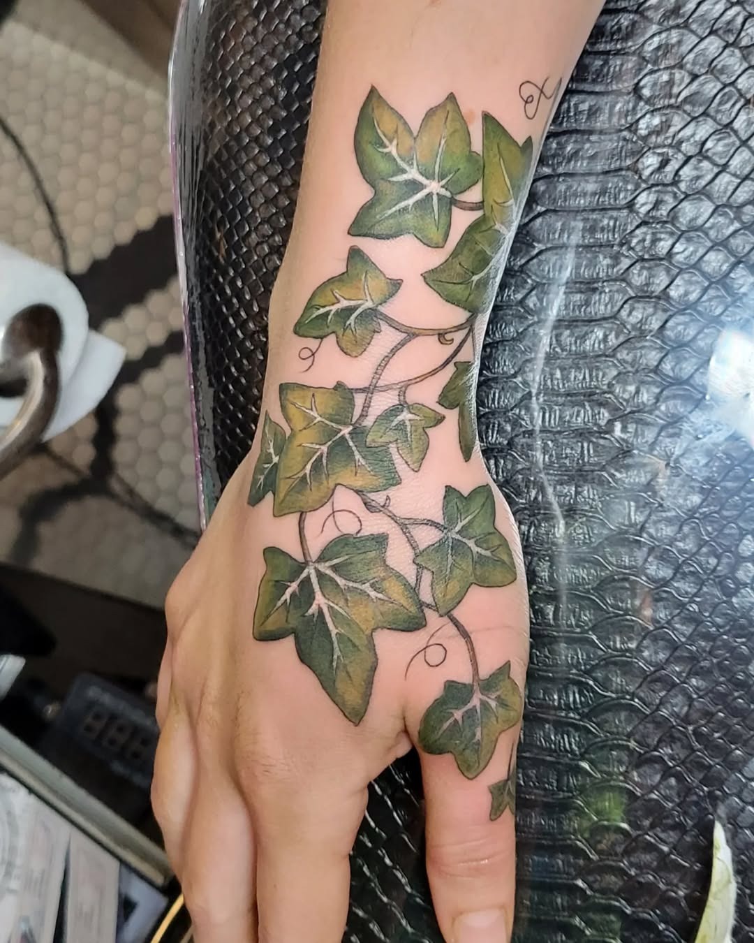 Elegant ivy tattoo wrapping around hand Tattoo Design