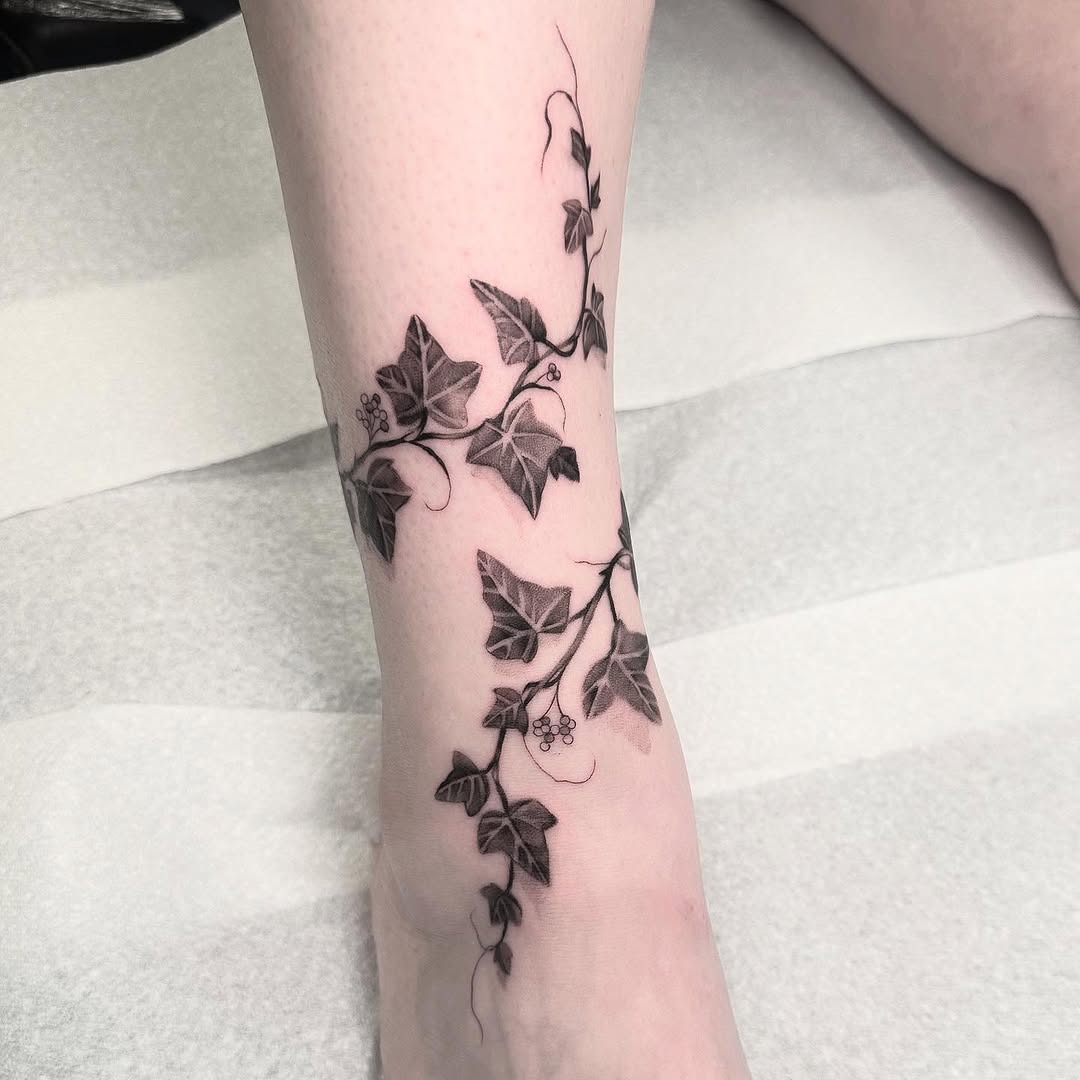 Elegant ivy tattoo wrapping around the leg Tattoo Design