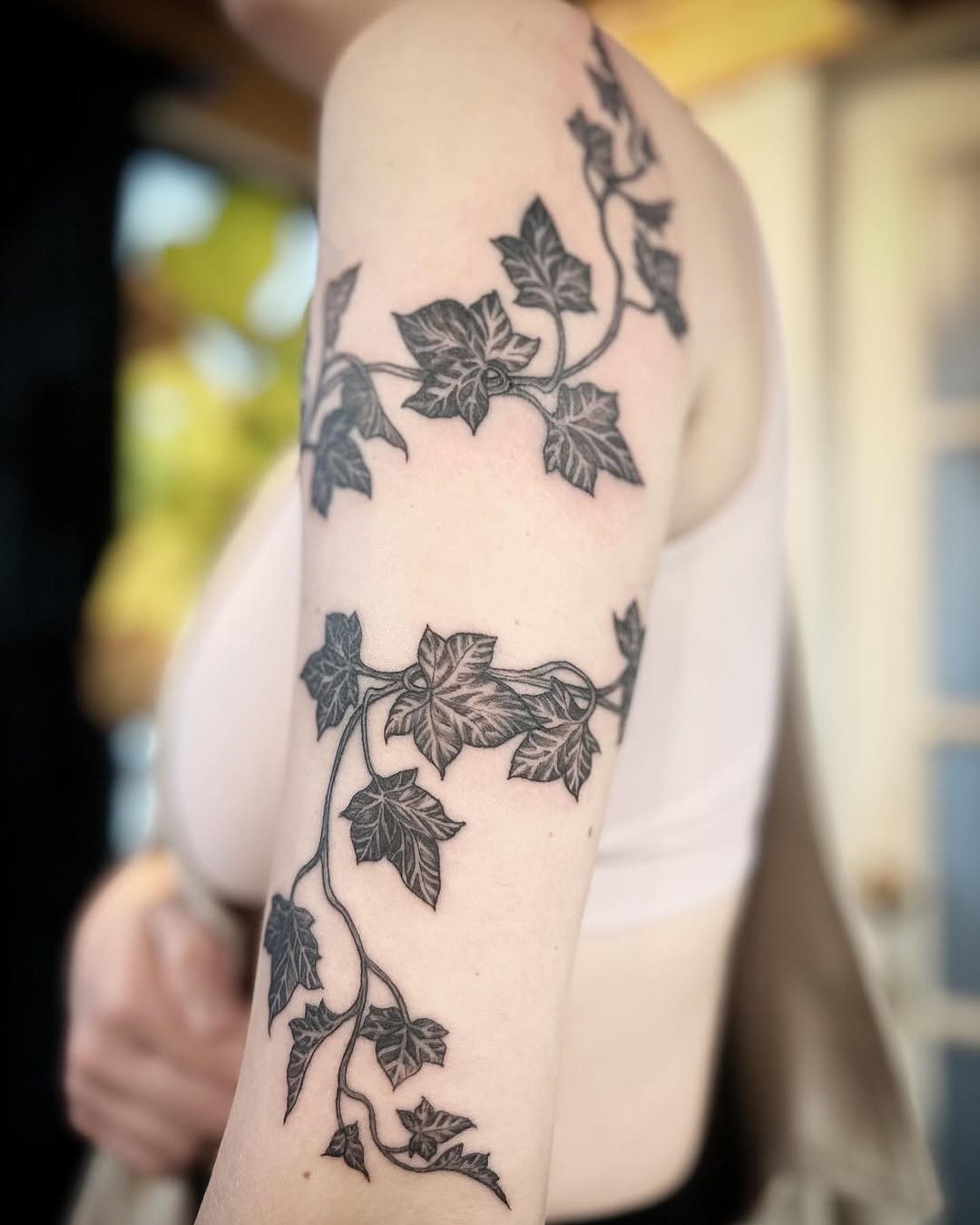 Elegant Ivy Tattoo Wraps Around Upper Arm Tattoo Design