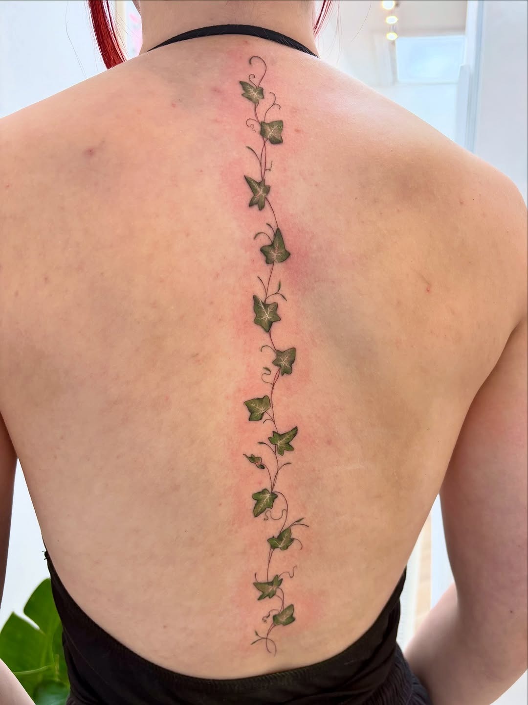 Elegant vertical ivy tattoo on the back Tattoo Design