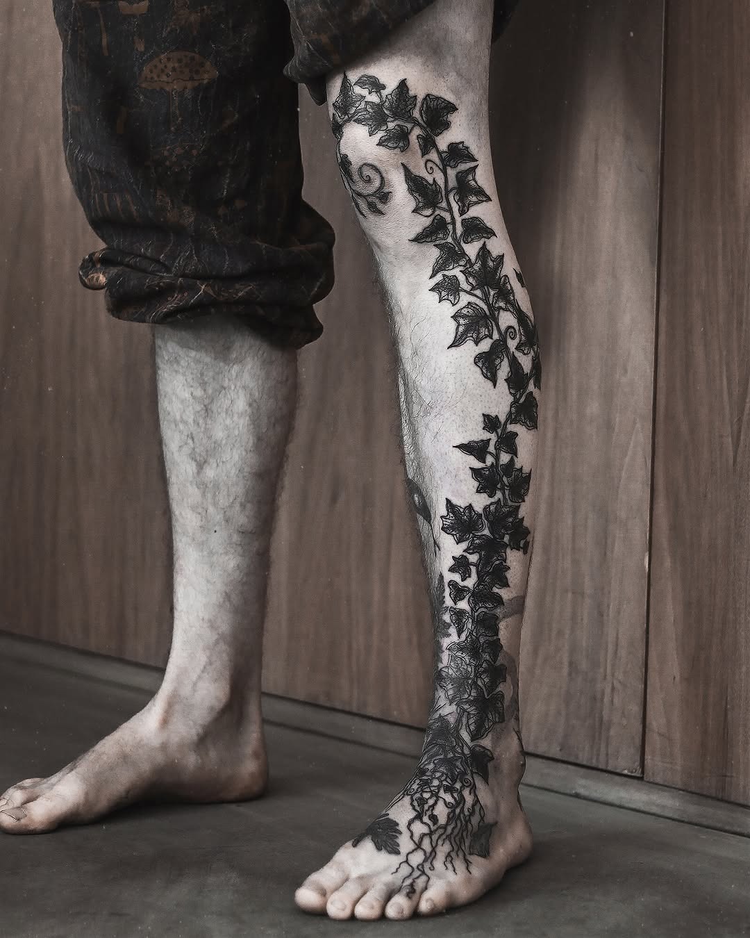 Intricate ivy tattoo wrapping around the leg Tattoo Design