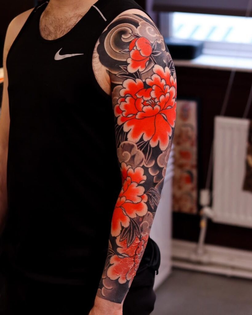 Bold Red Peonies and Blackout Sleeve Tattoo Design