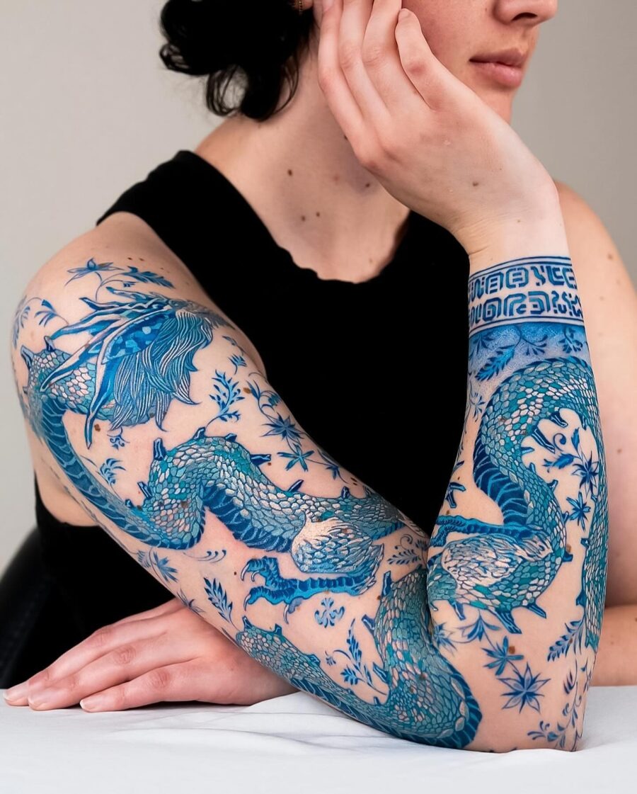 Elegant Japanese dragon tattoo with floral details Tattoo Design