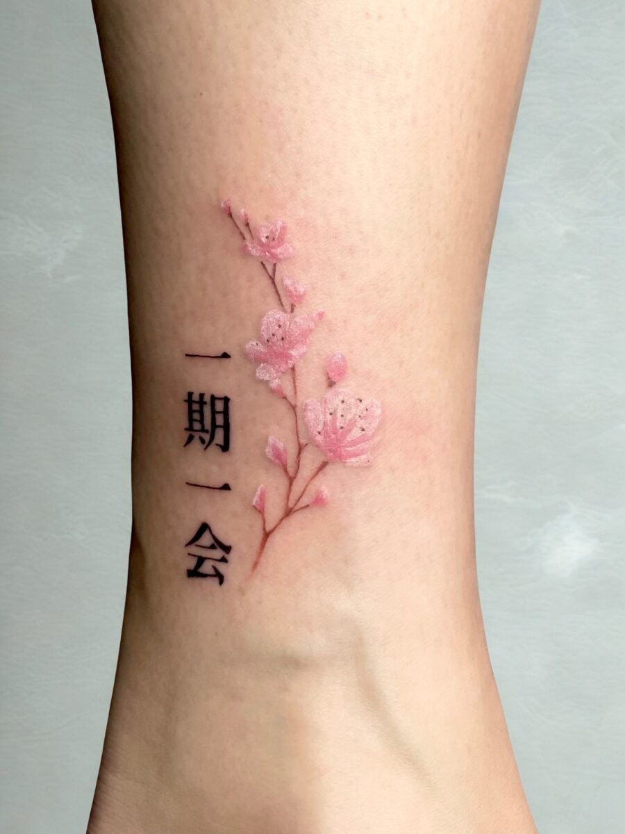 Elegant Japanese flower tattoo with meaningful text Tattoo Design