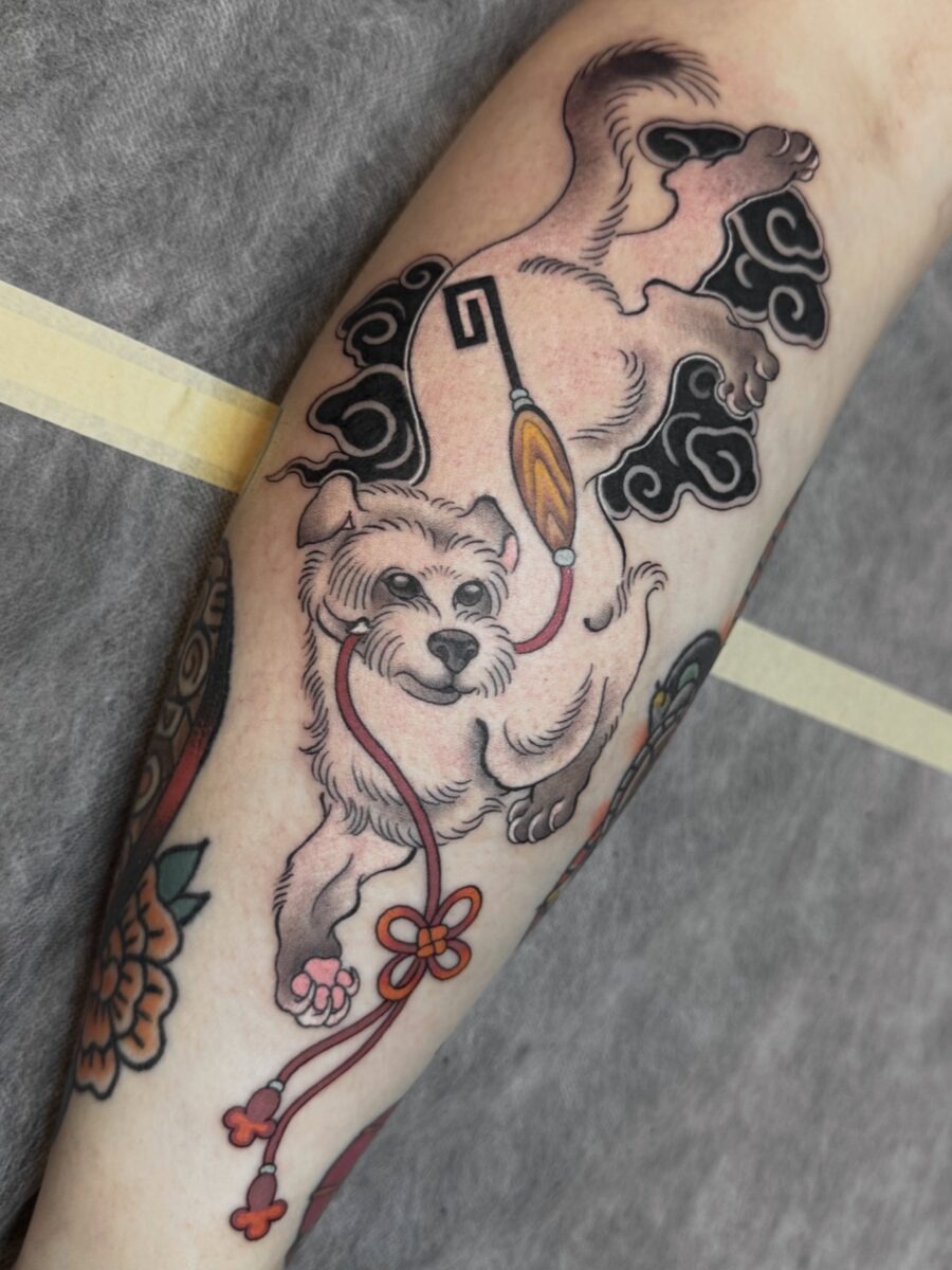Japanese dog tattoo with playful elements Tattoo Design