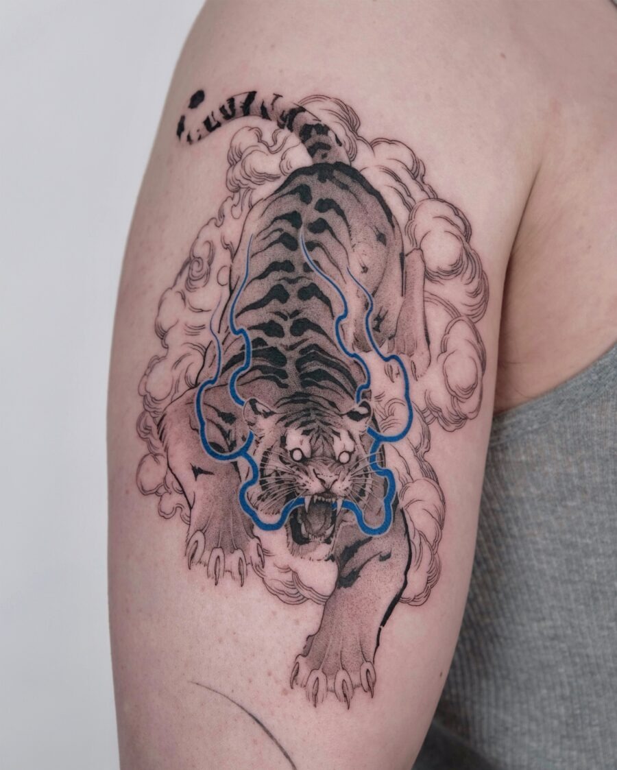 Powerful tiger tattoo surrounded by mystical clouds Tattoo Design