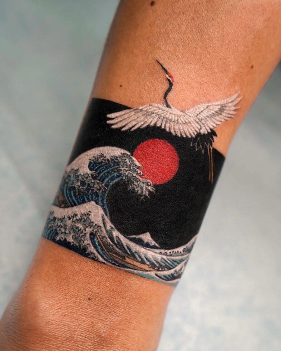 Stunning crane soaring above ocean waves Tattoo Design