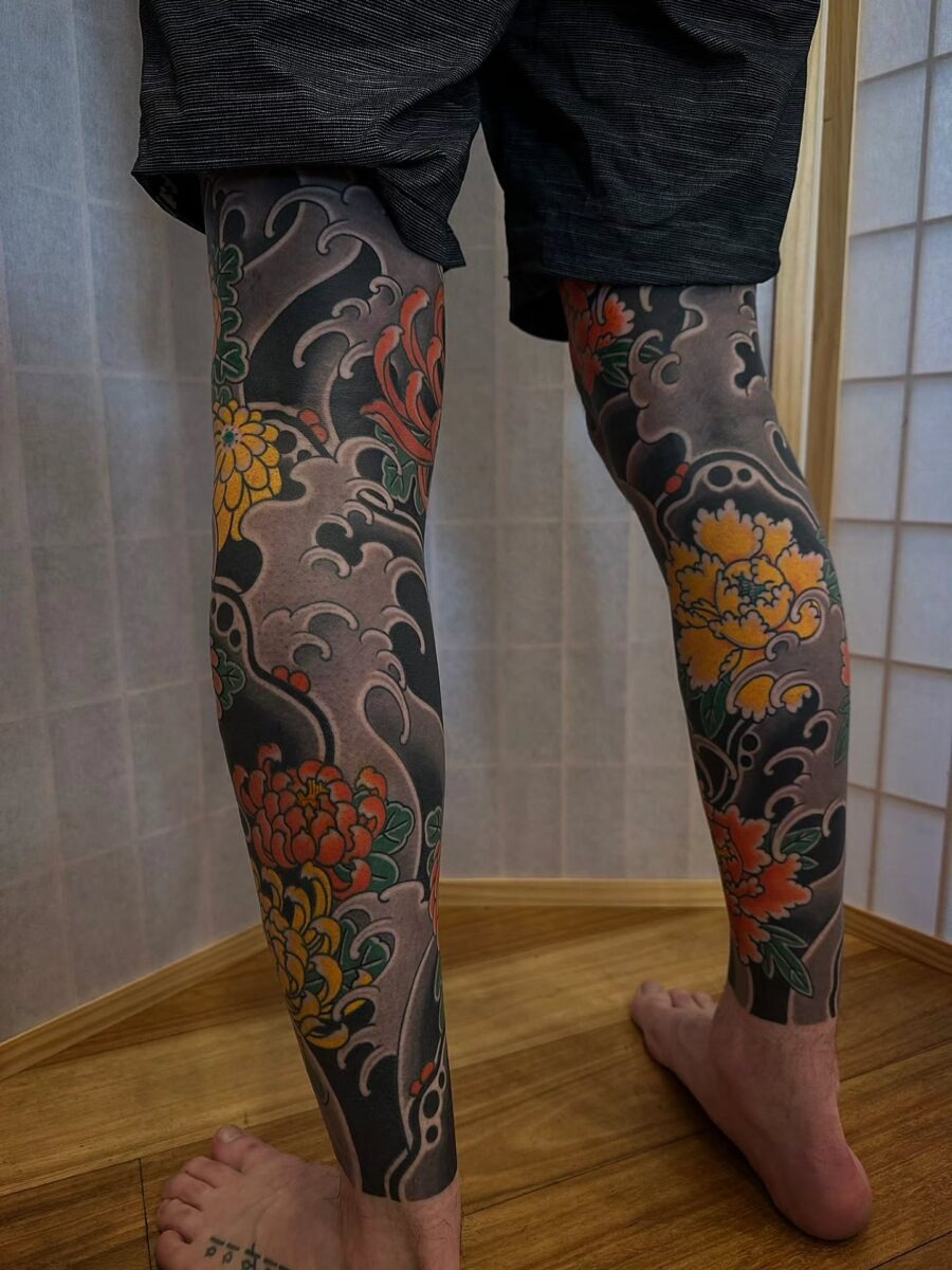 Vibrant floral Japanese tattoos adorn the legs Tattoo Design