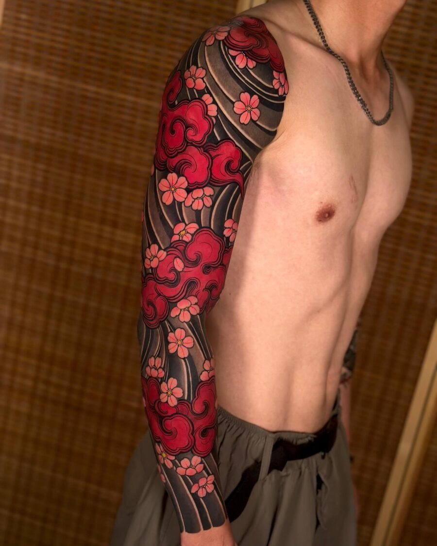 Vibrant Japanese Sleeve Tattoo with Floral Accents Tattoo Design