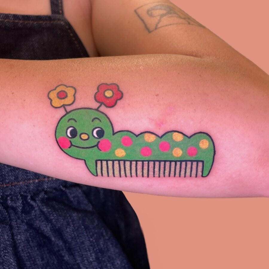 Whimsical caterpillar tattoo with vibrant colors Tattoo Design