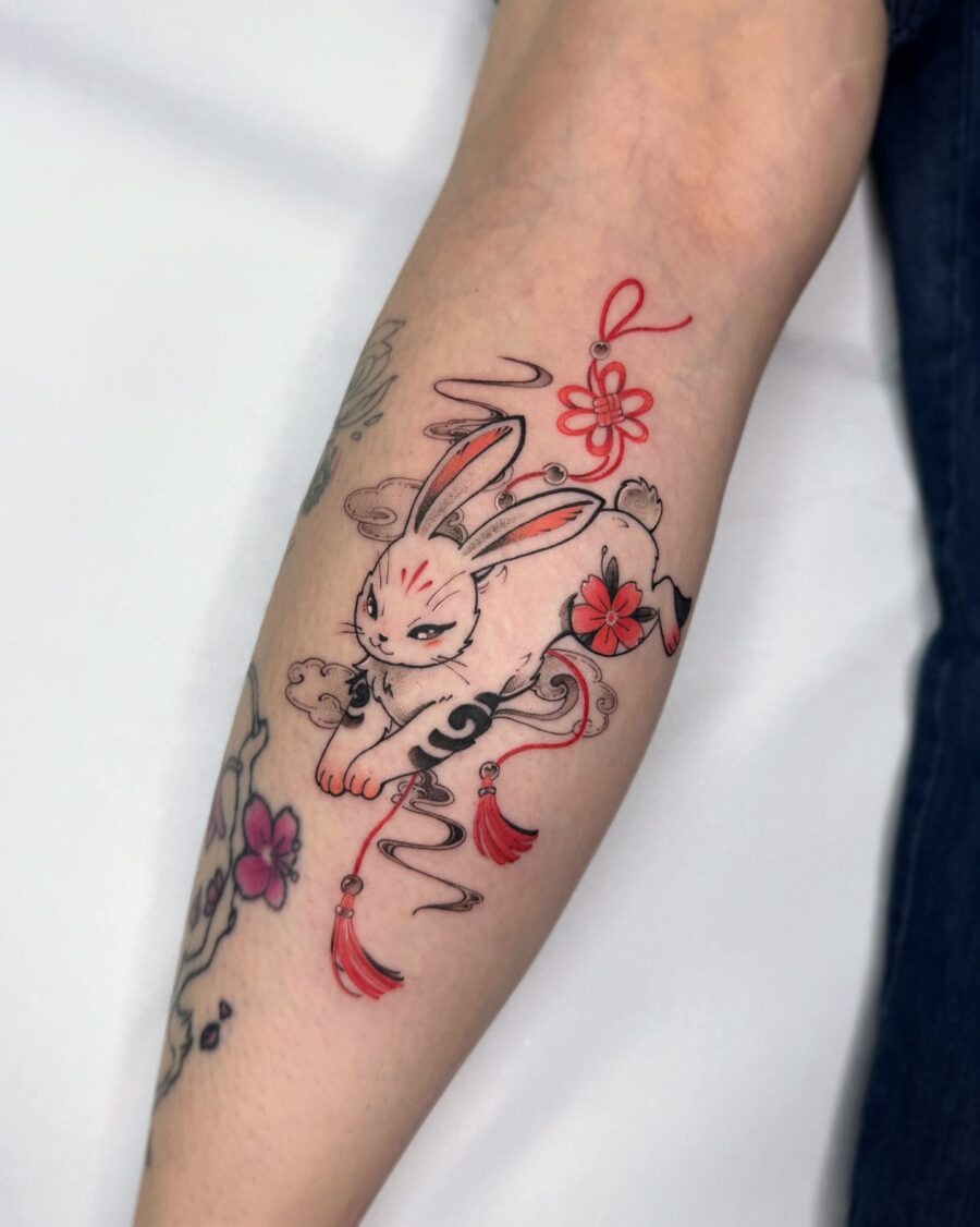 Whimsical rabbit tattoo with floral elements Tattoo Design