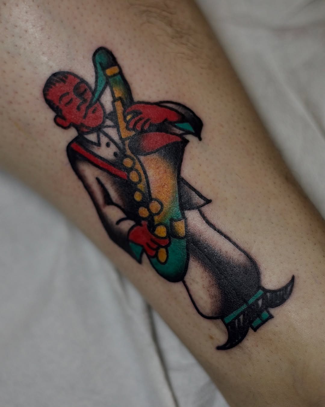Colorful saxophonist tattoo celebrating jazz culture Tattoo Design
