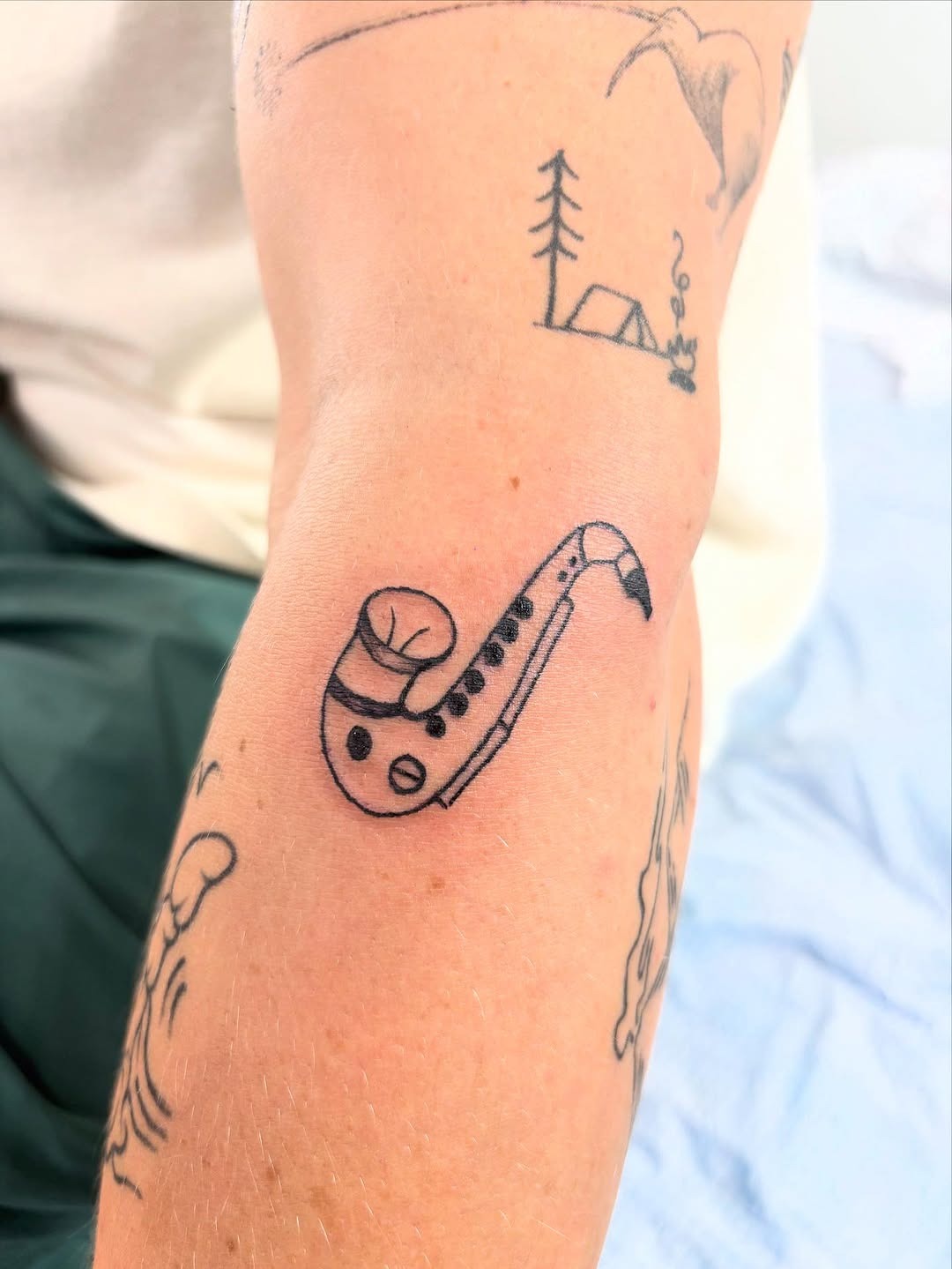 Unique saxophone tattoo with a minimalist design Tattoo Design