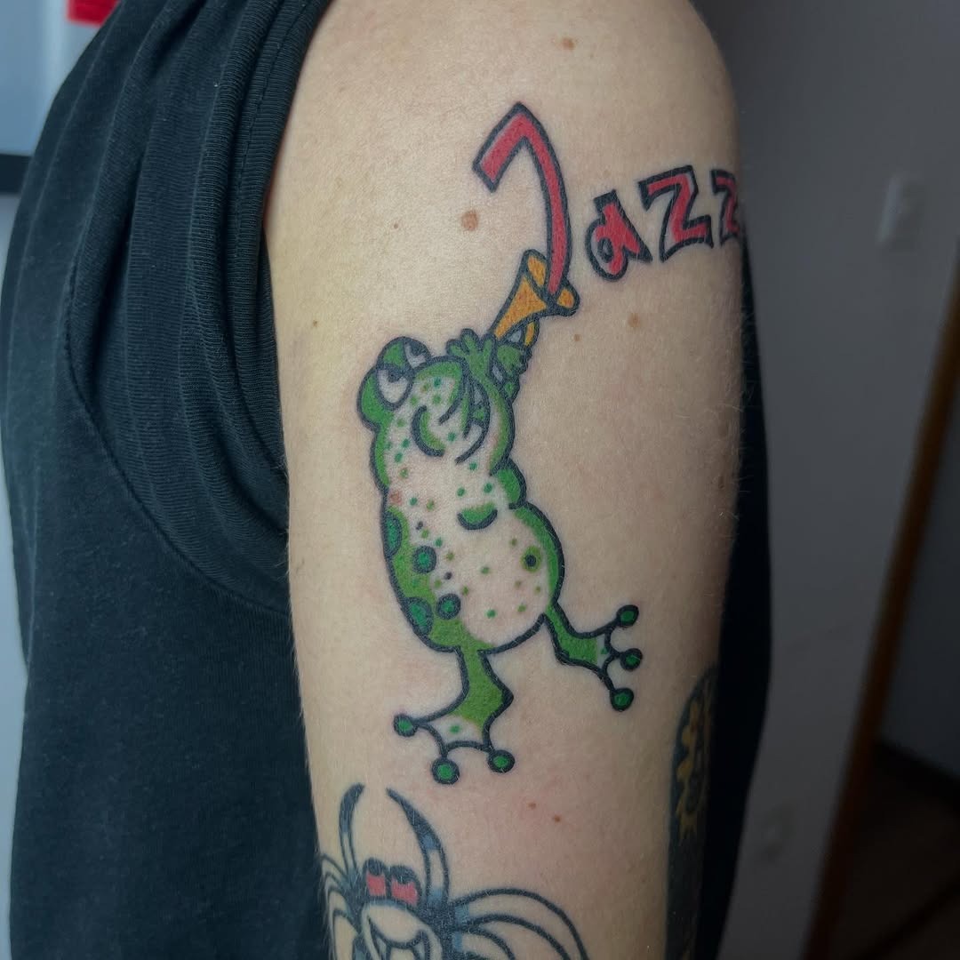 Whimsical jazz-loving frog tattoo design Tattoo Design