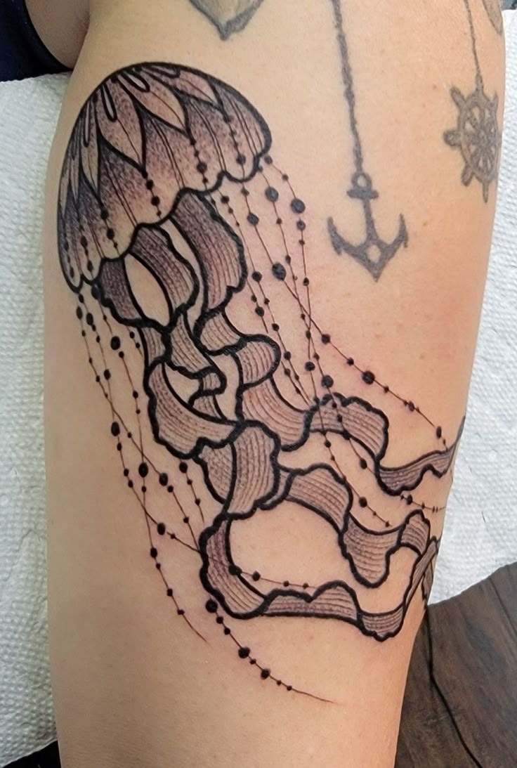 Dotwork jellyfish tattoo with geometric circle frames and intricate stippled shading