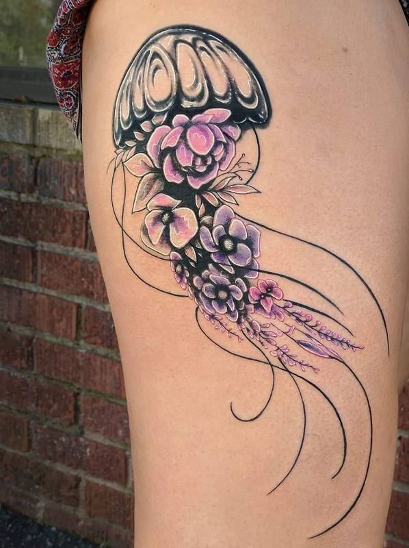 Black and grey illustrative jellyfish tattoo with a blooming chrysanthemum forming the inner bell