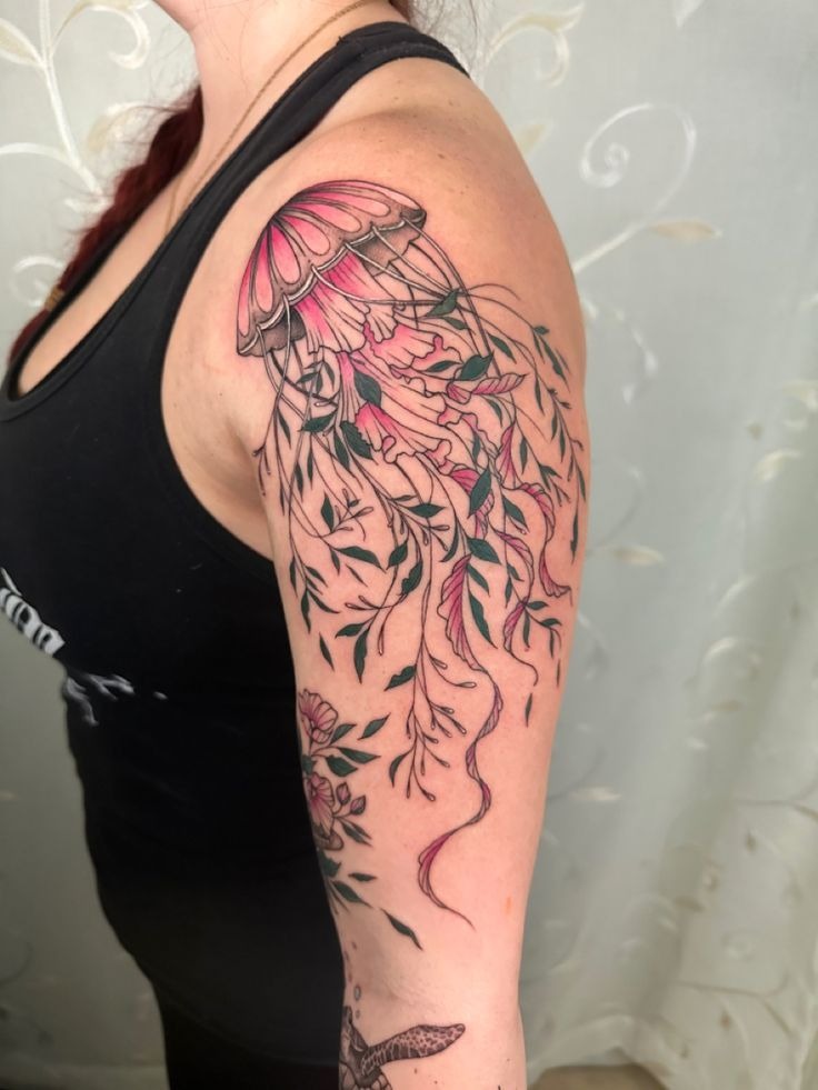 Botanical jellyfish tattoo crafted entirely from eucalyptus and fern leaves on forearm