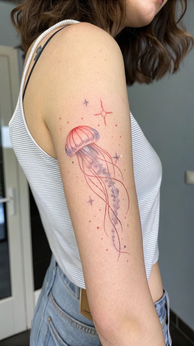 Fine line pink jellyfish thigh tattoo featuring delicate micro dotwork and trailing tentacles