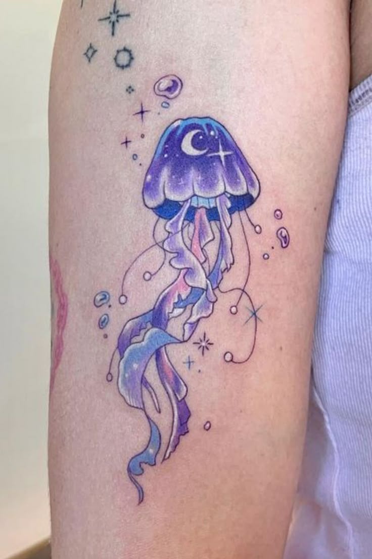 Deep violet and magenta jellyfish tattoo featuring lunar phase symbols across the dome