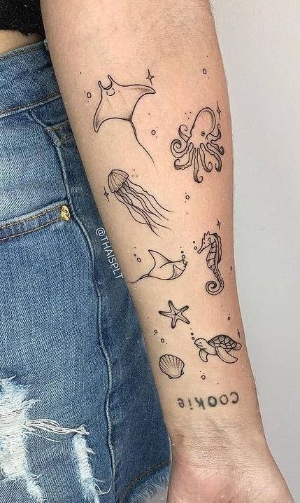 Whimsical illustrative sea creature tattoo featuring small jellyfish and ocean drifters