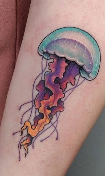 Warm gradient jellyfish tattoo featuring apricot, coral, and golden yellow ink tones