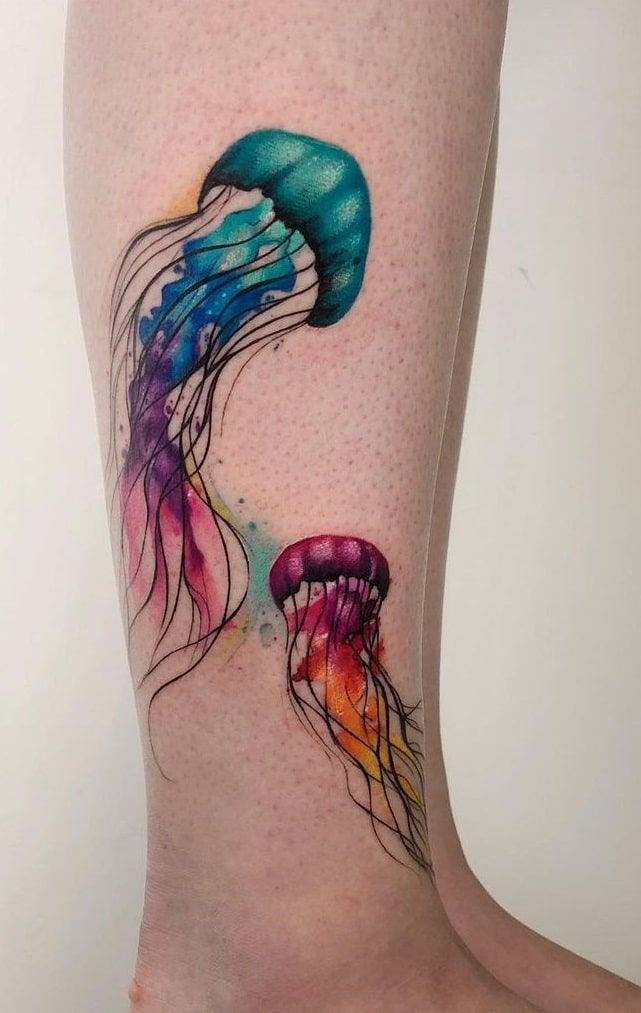 Pair of watercolor jellyfish swimming together with turquoise and violet tentacles on arm