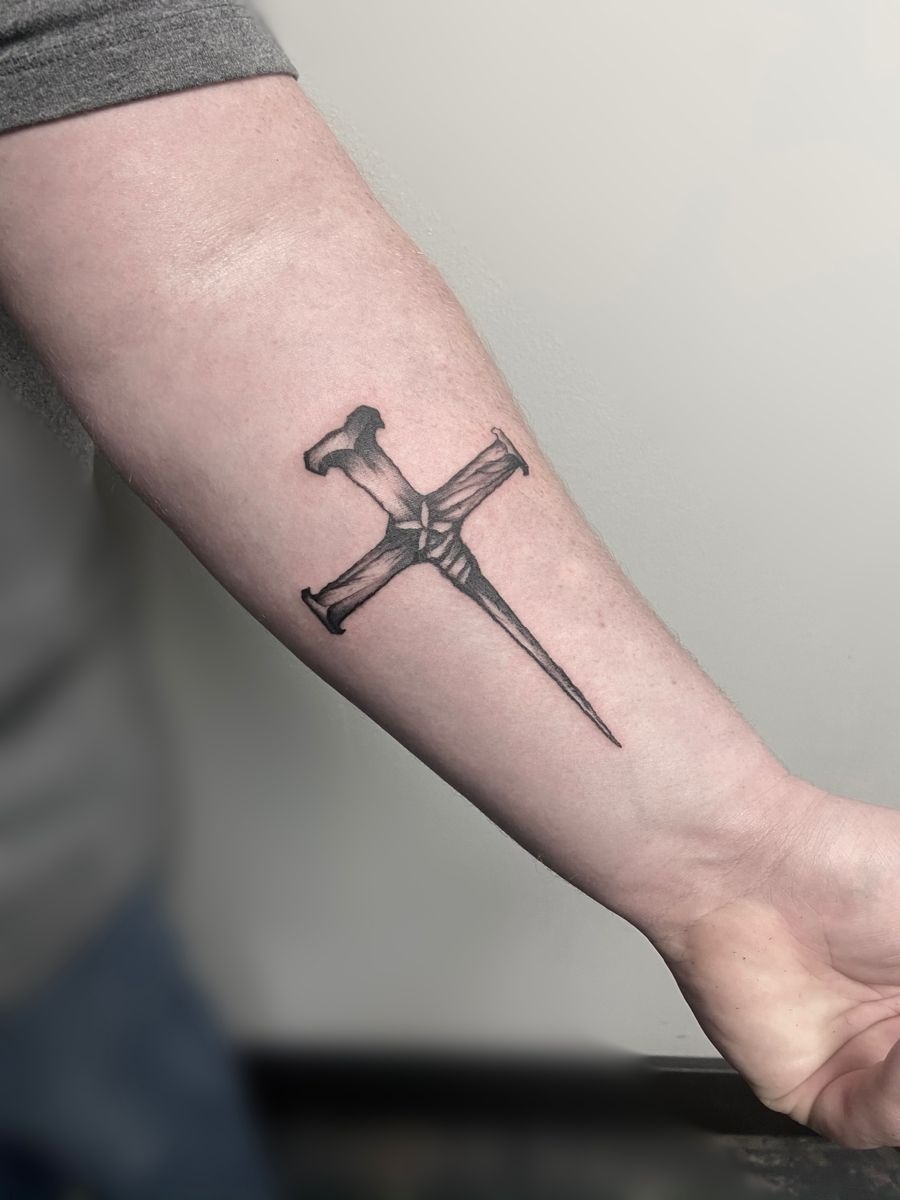 Rugged Cross Tattoo with a Nail Base Tattoo Design