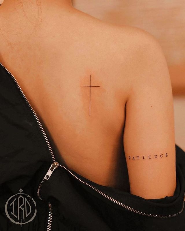 Thin Cross Tattoos on the Shoulder with Matching Word Tattoo Design