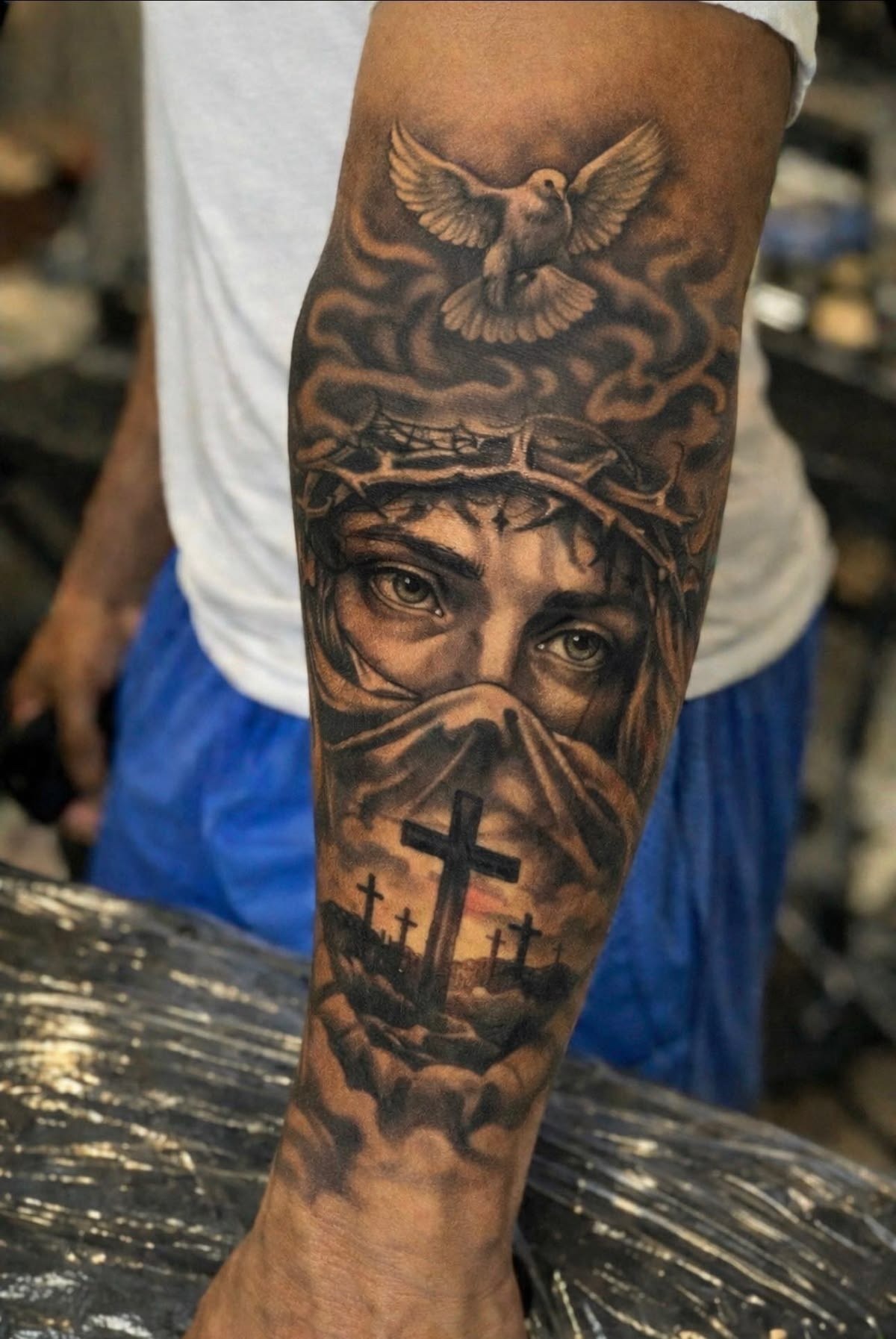 Jesus Eyes, Dove, and Crosses Sleeve Tattoo Design