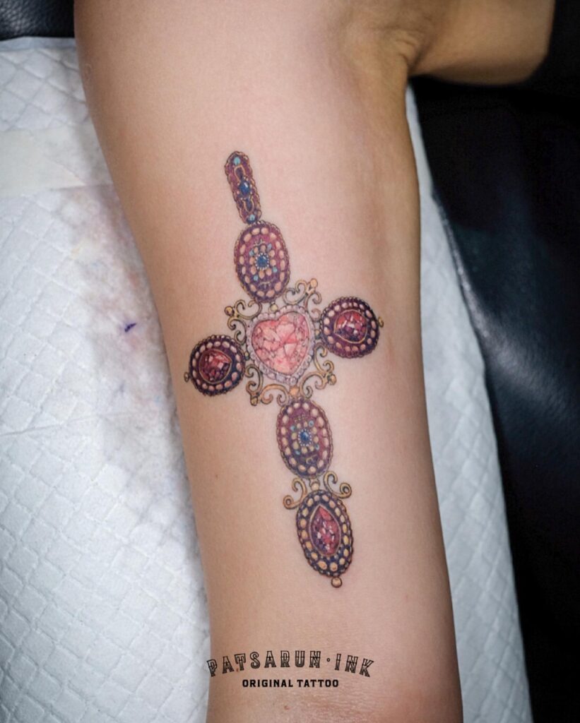 Ornate Ruby Cross Tattoo with Heart Centerpiece Tattoo Design