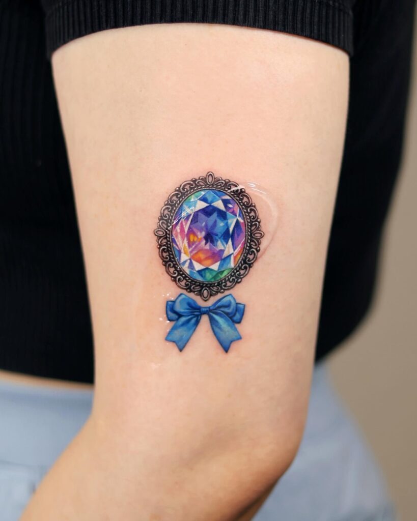 Rainbow Gem Cameo with Blue Bow Tattoo Tattoo Design