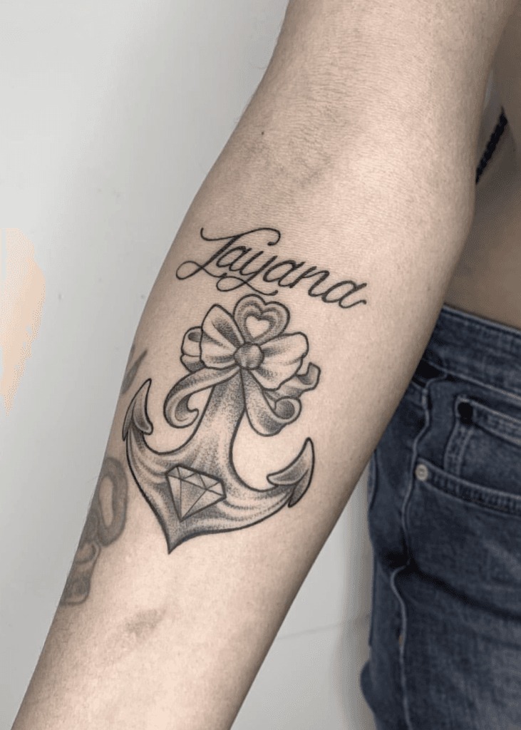 Mother Holding Daughter with Name & Floral Decorations Tattoo Design