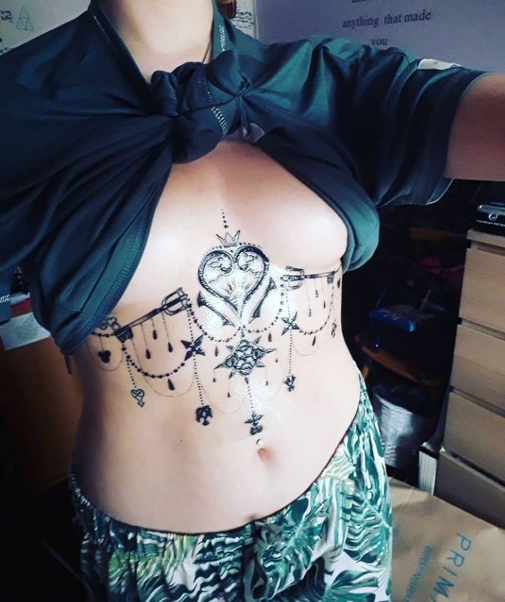 Ornate Underbust Heart and Keyblade Piece Tattoo Design