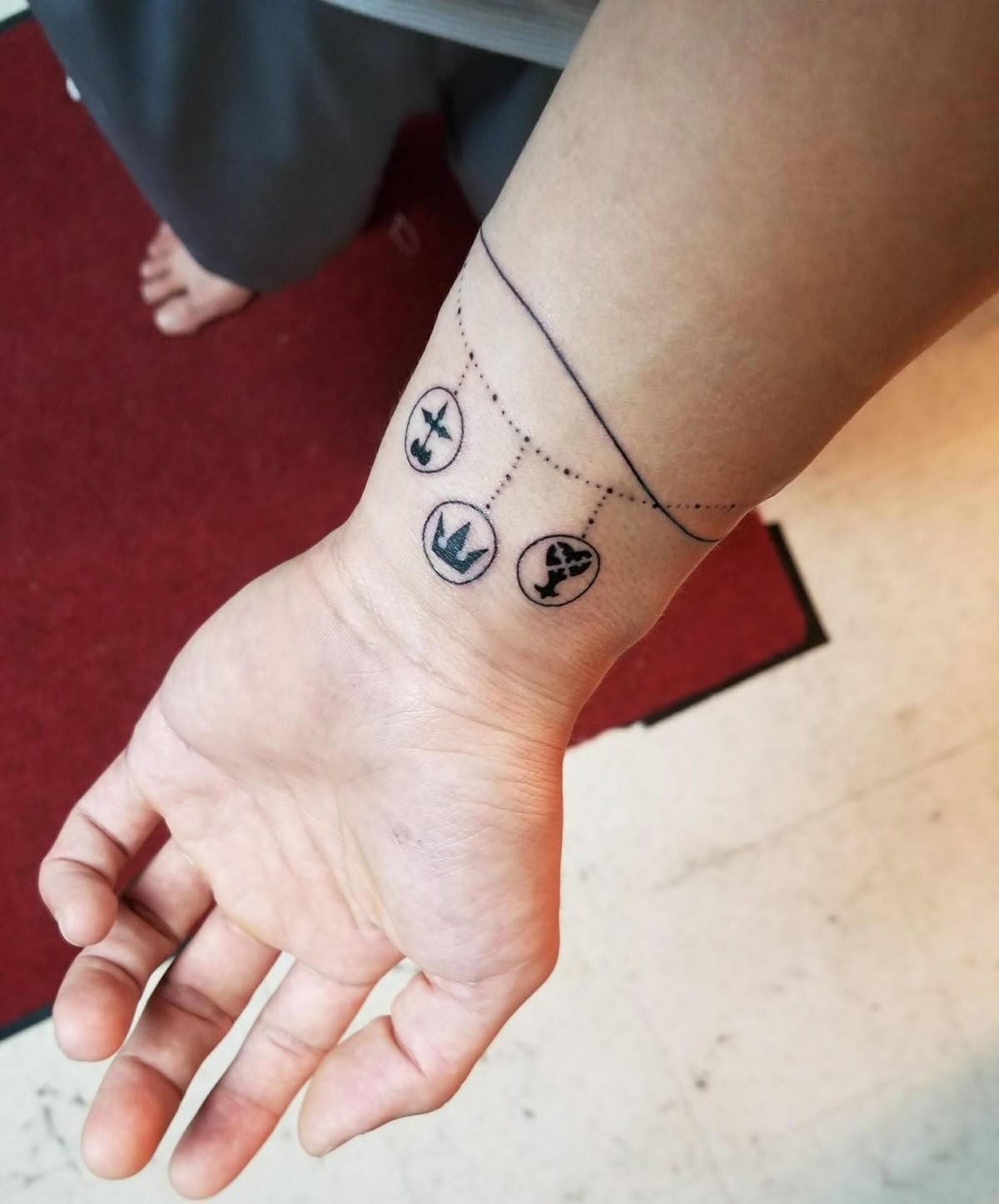 Tiny Symbol Bracelet on the Wrist Tattoo Design
