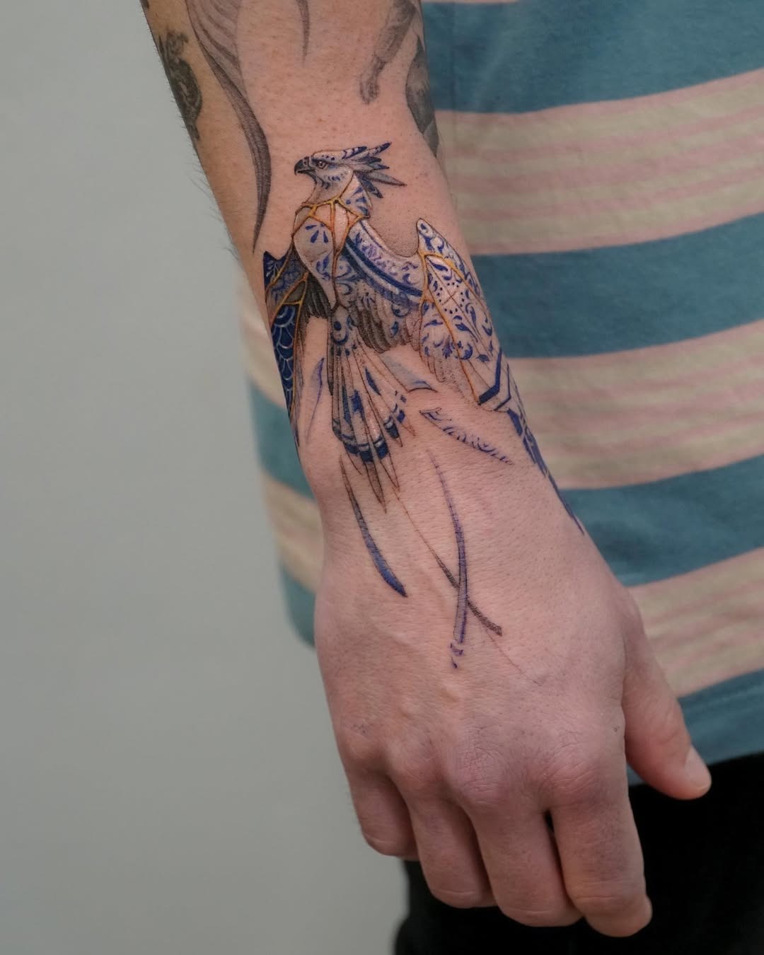 Elegant Kintsugi Bird Tattoo on Forearm Tattoo Design