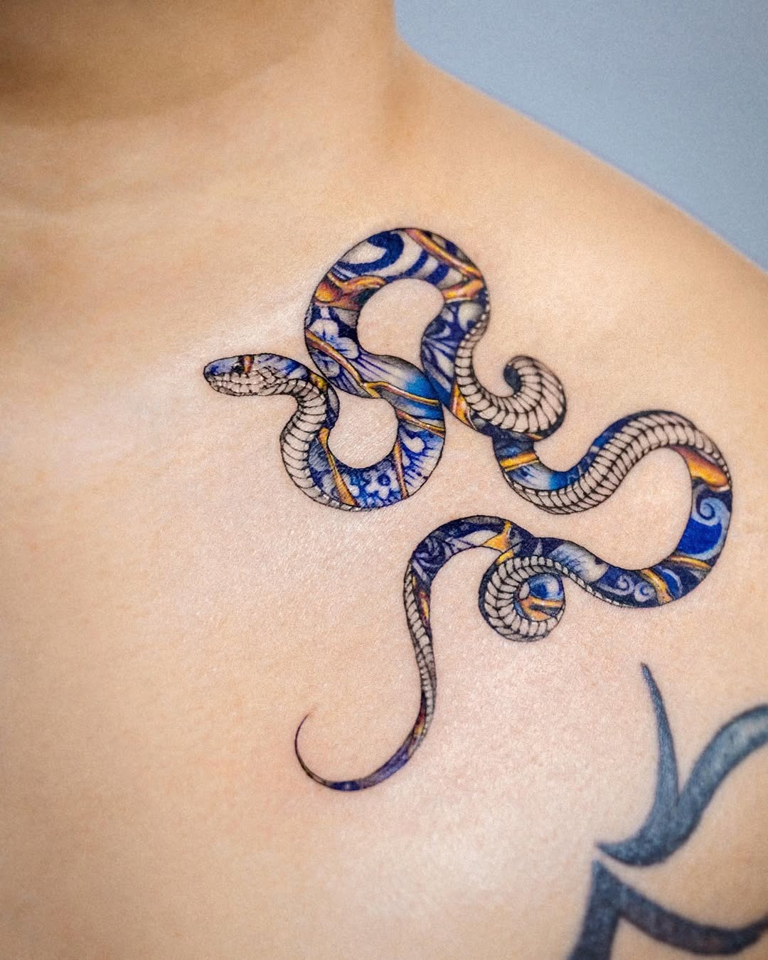 Vibrant Kintsugi Snake Tattoo on Skin Tattoo Design