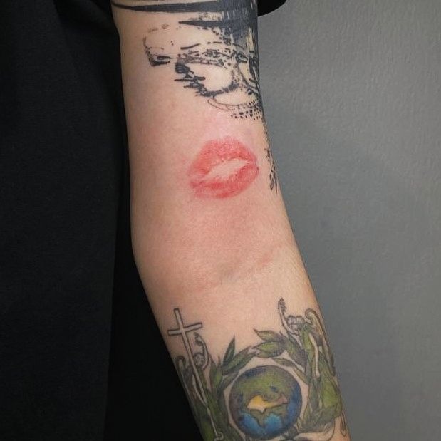 Faded Lip Kiss with Layered Tattoos Tattoo Design
