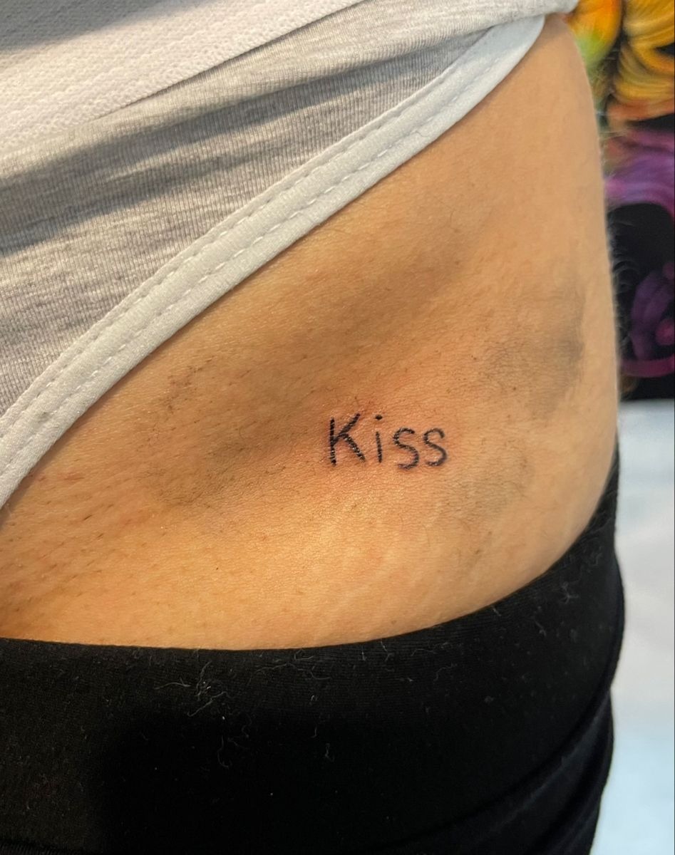 Tiny "Kiss" Script Tattoo on Hip Tattoo Design