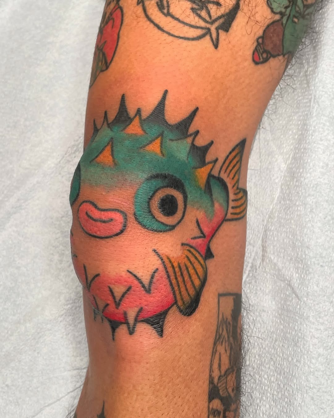 Colorful pufferfish knee tattoo design inspiration Tattoo Design