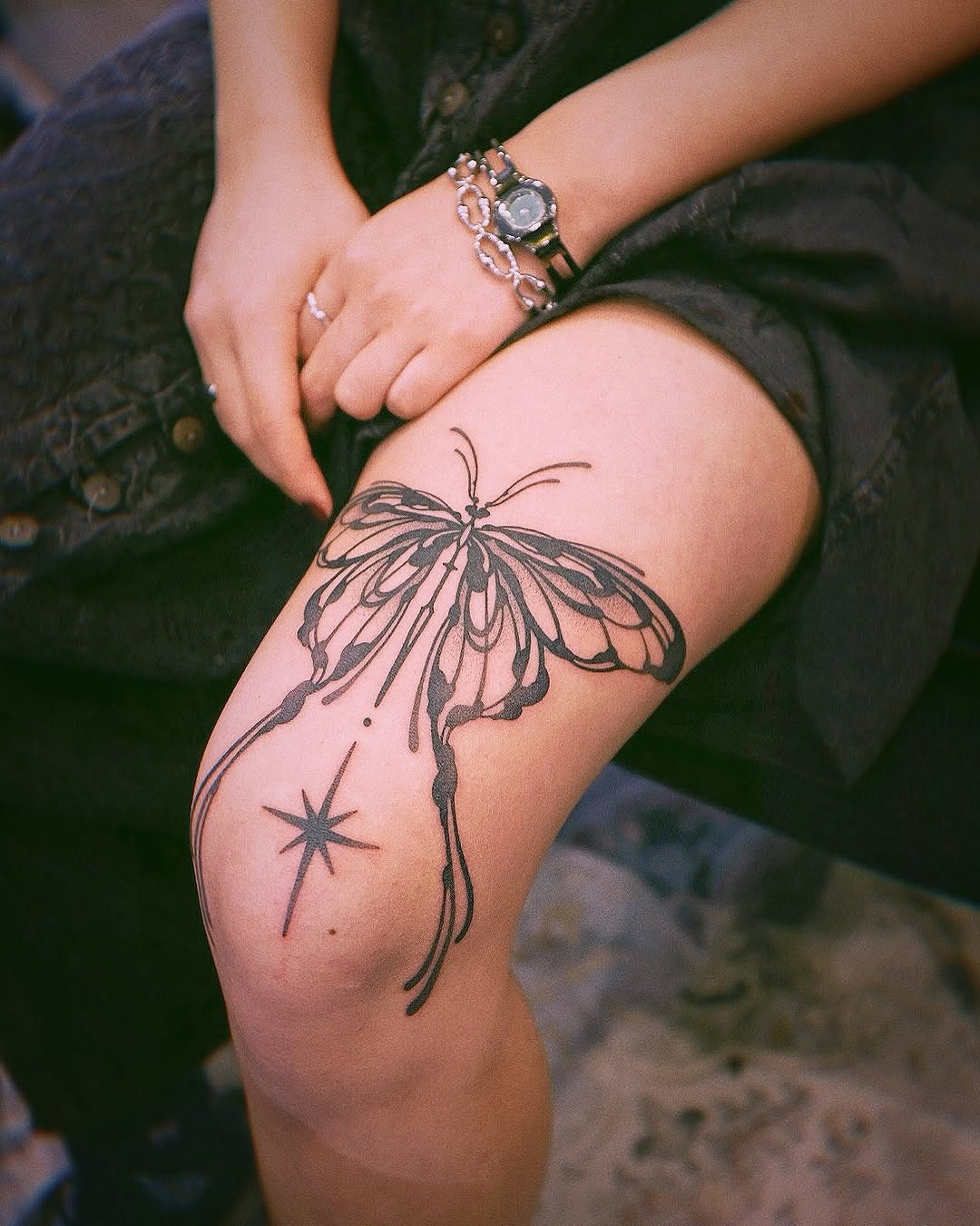 Elegant butterfly knee tattoo with star accent Tattoo Design