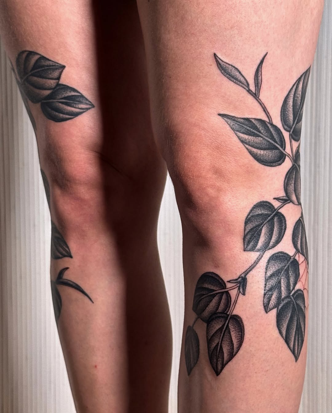 Elegant leaf designs wrap around the knees. Tattoo Design