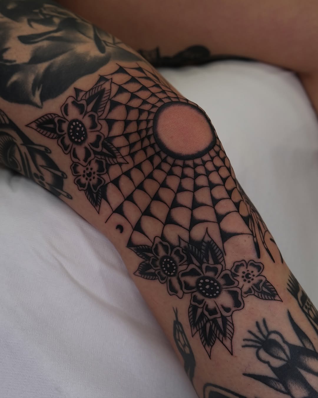 Striking knee tattoo with spider web design Tattoo Design