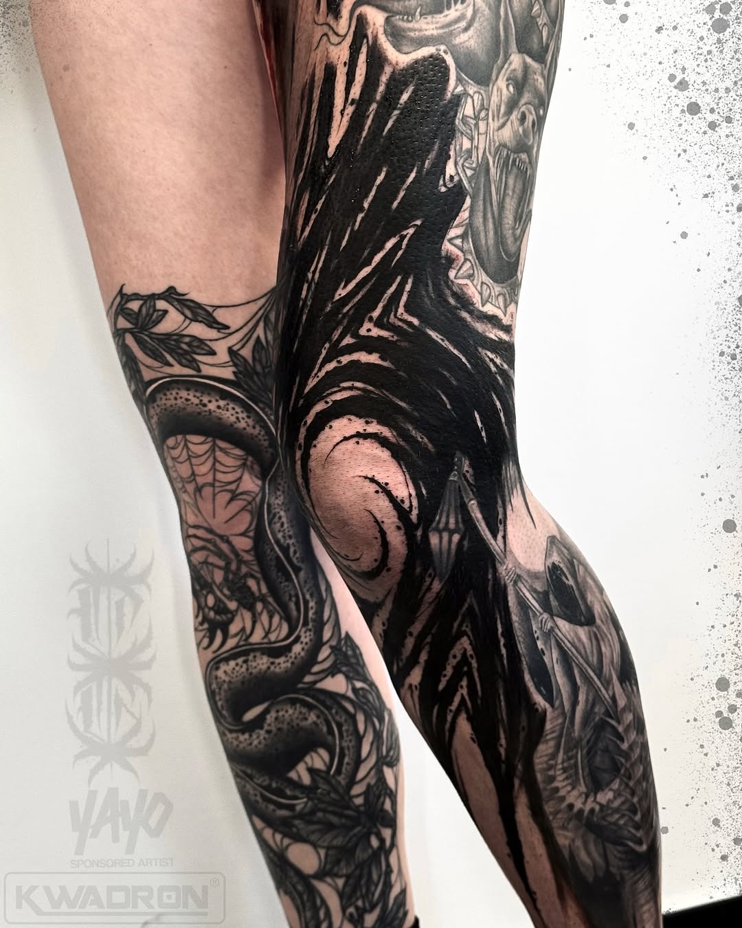 Striking knee tattoos with black and gray designs Tattoo Design