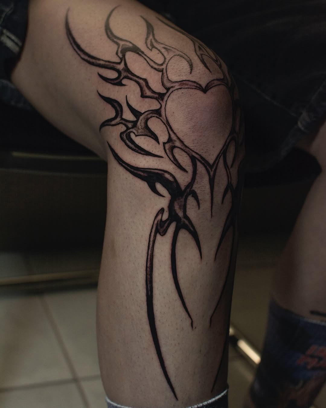 Striking tribal heart knee tattoo design Tattoo Design