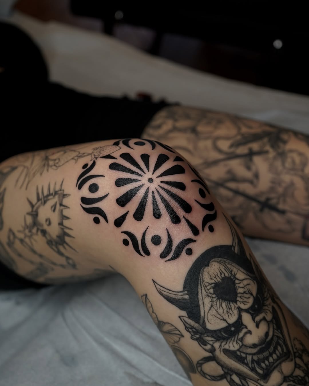 Stunning floral knee tattoo in bold black ink Tattoo Design