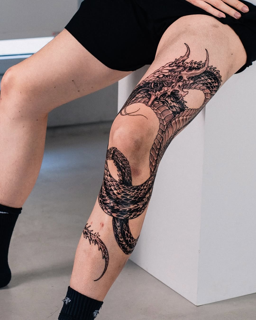 Stunning knee dragon tattoo design in black ink Tattoo Design